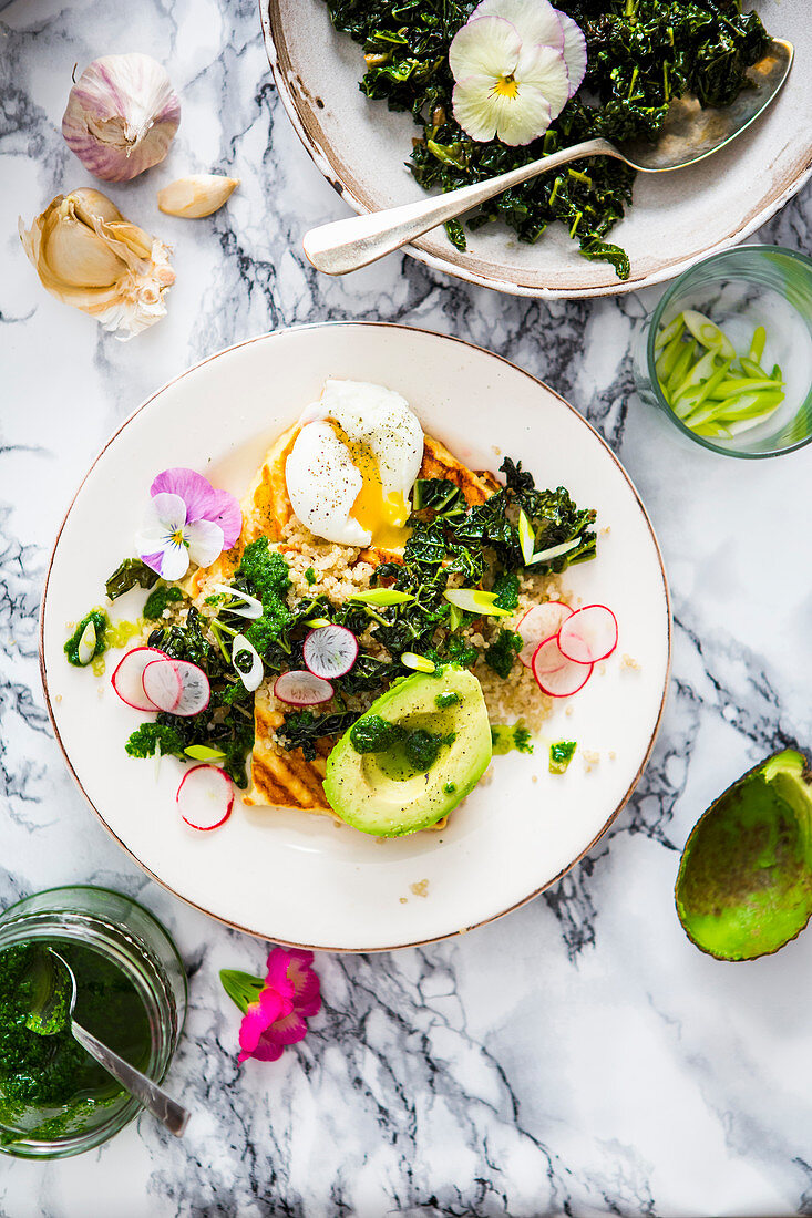 Warm salad with quinoa, cabbage, avocado and poached egg