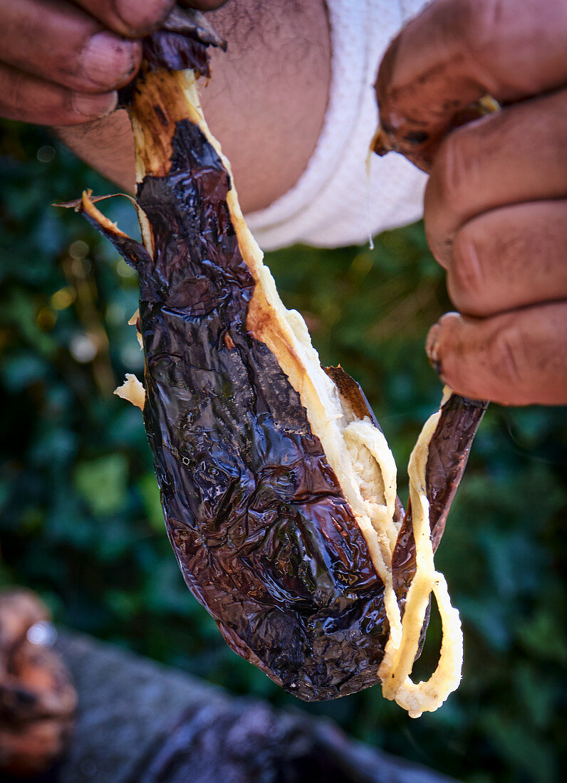 An aubergine being skinned