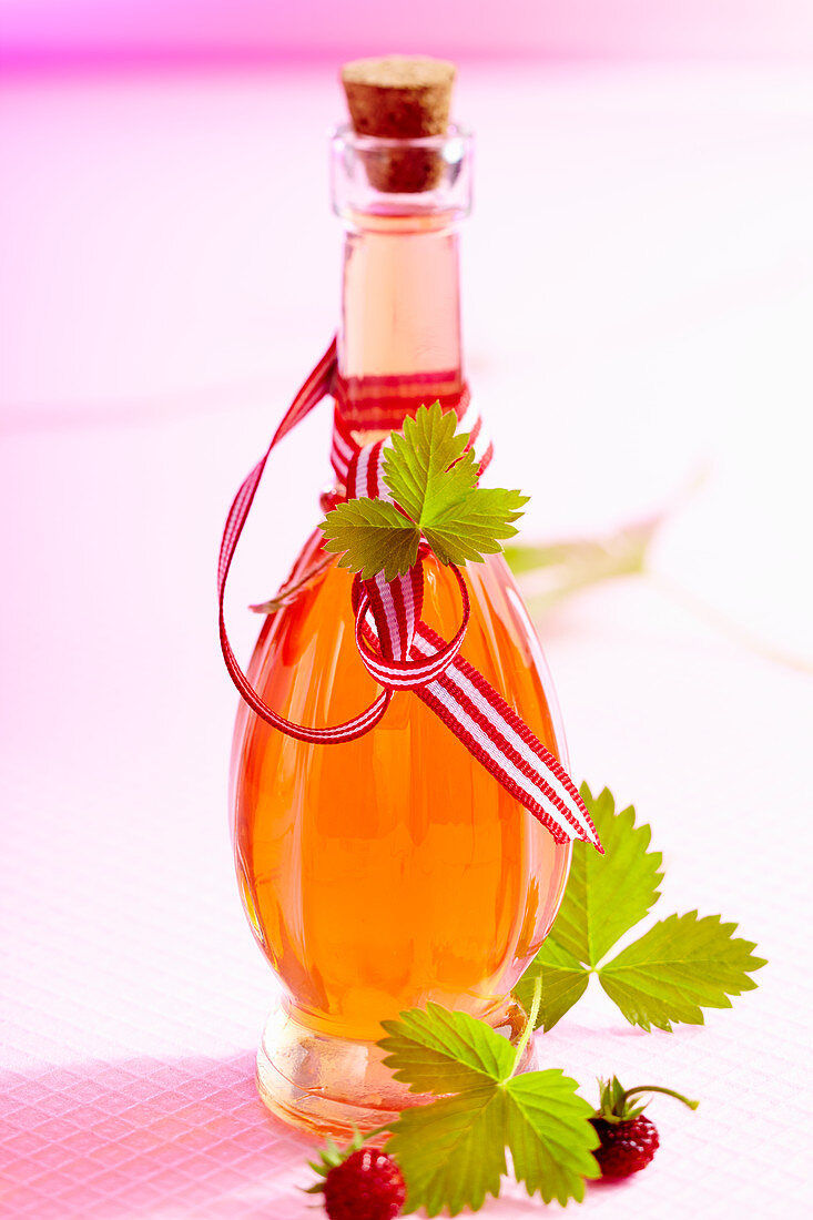 Homemade strawberry liqueur with fresh wild strawberries, wine spirit, rock sugar and vanilla