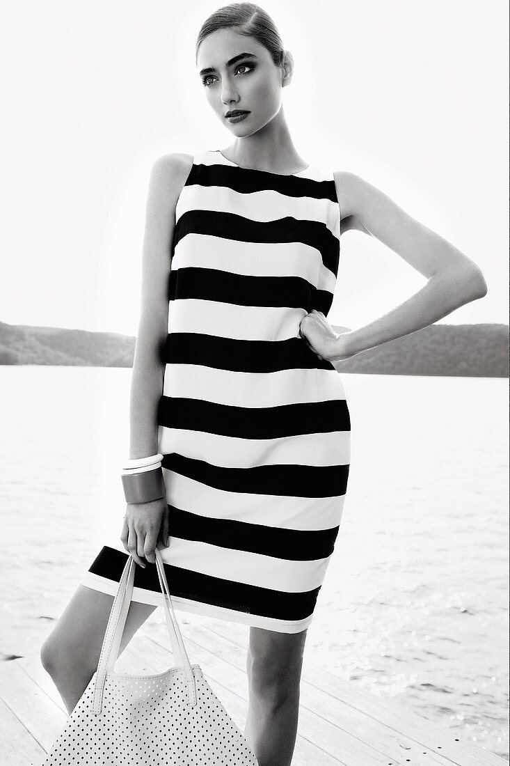 A young woman wearing a striped summer dress (black-and-white shot)