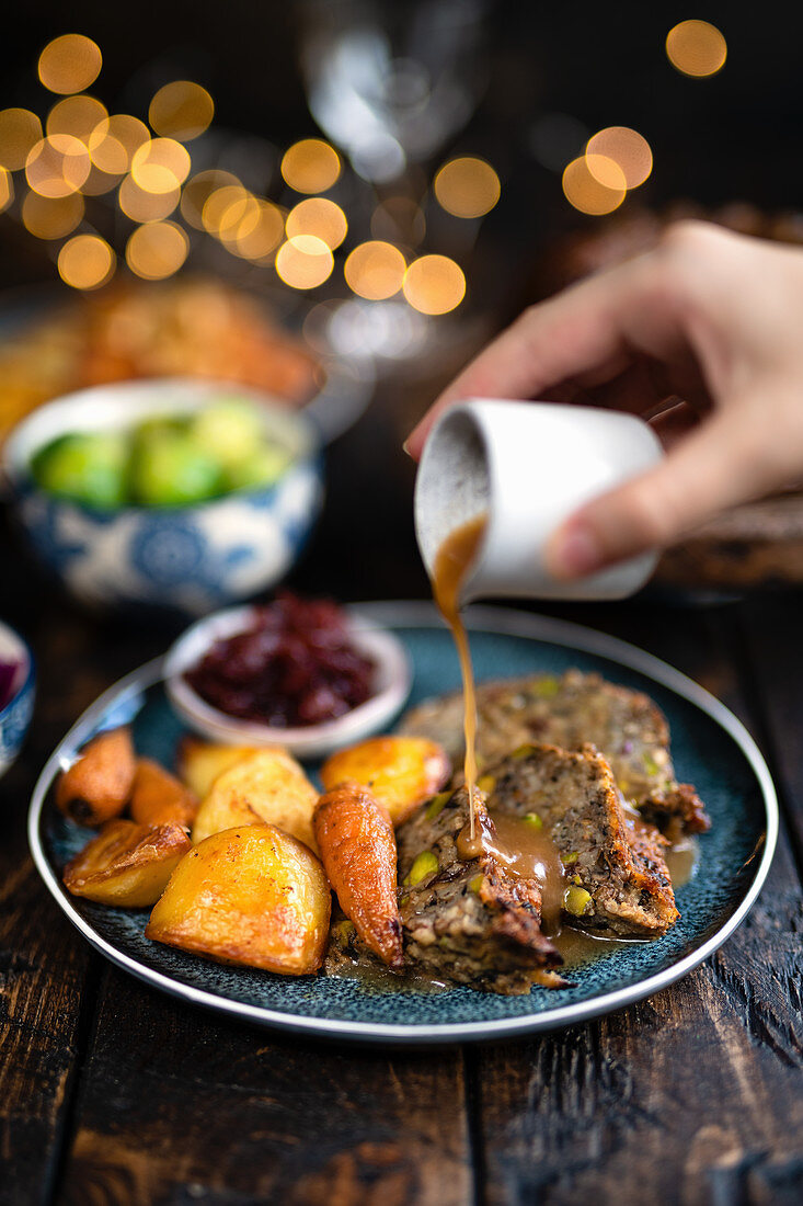 Vegetarian nut roast with roast vegetables and gravy