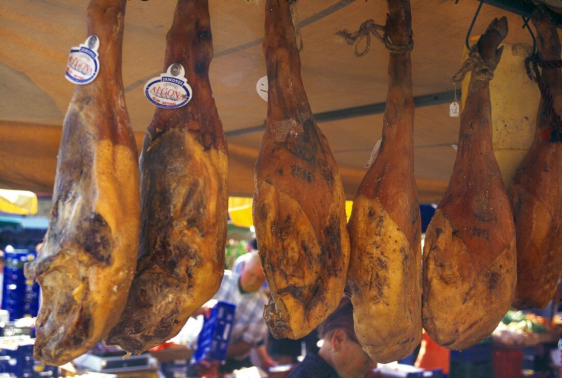 Pieces of Pork Hanging in a Meat Market