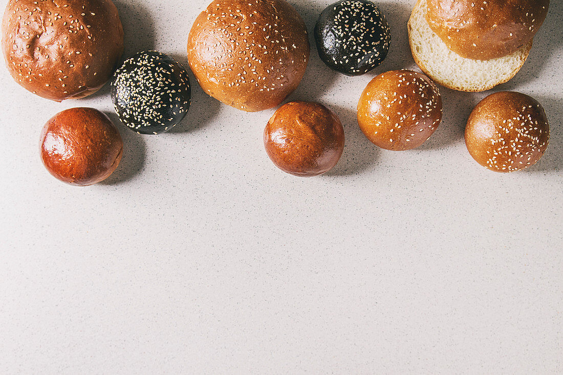 Homemade traditional and black cuttlefish ink different size burger buns with sesame seeds