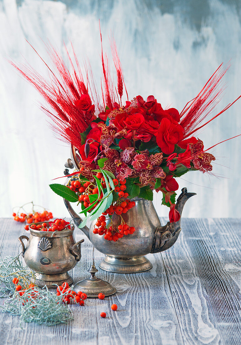 Bouquet of red-dyed barley, begonias, rowan berries and poor-man's orchids