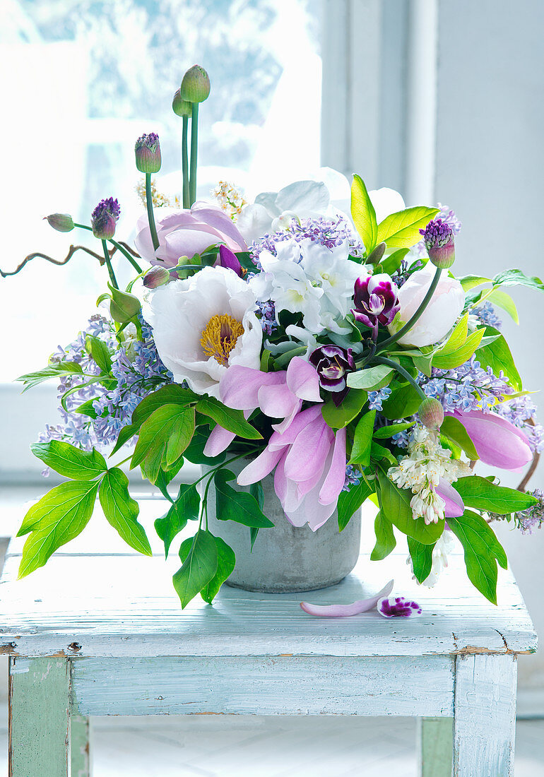 Bouquet of magnolia, peonies, lilac and alliums