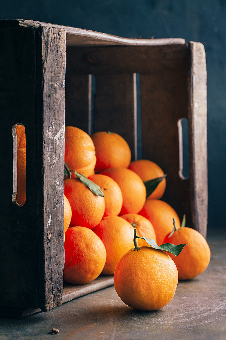 Fresh oranges in an old wooden box