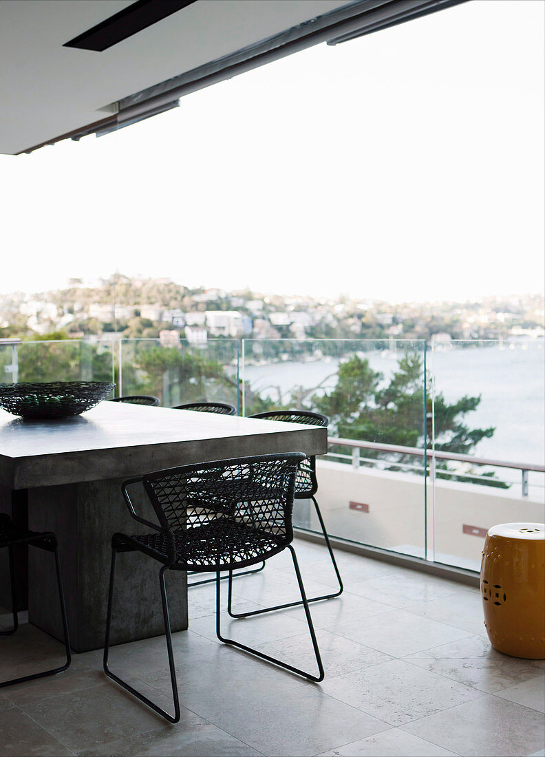 Dining table on the terrace with glass balustrade and panorama