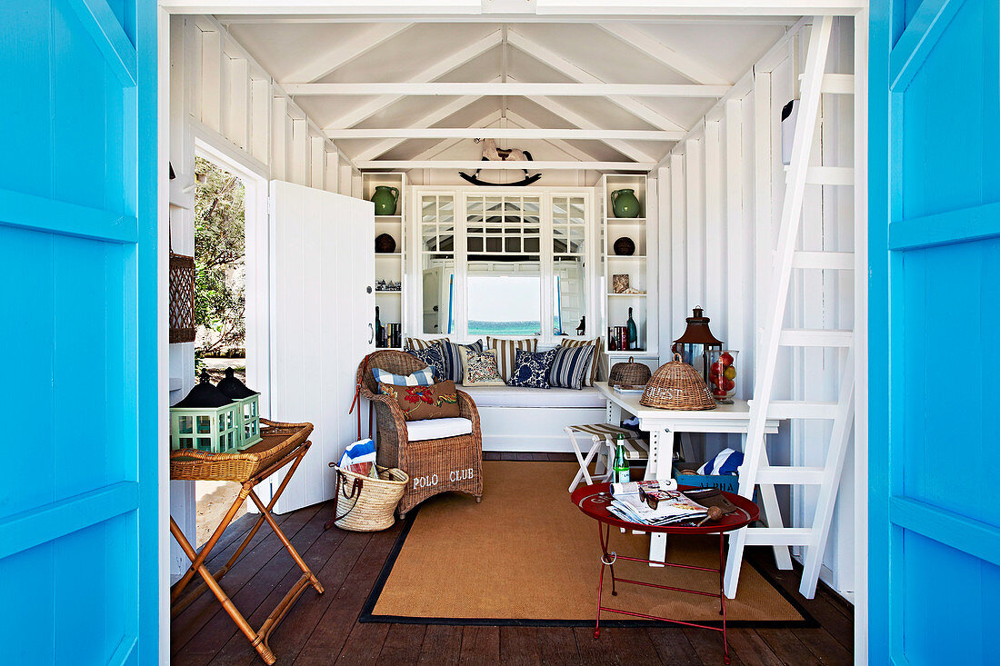 View through open blue doors into a cozy beach house