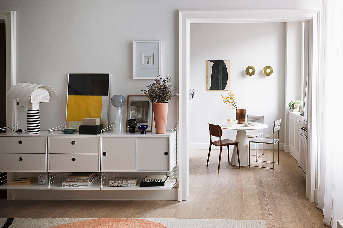 Floating sideboard next to open doorway with view of dining table