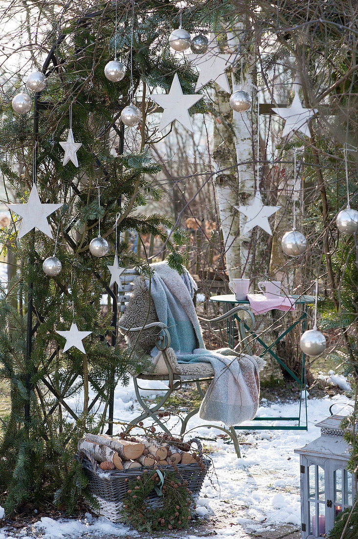 Seat under the rose arch that has been decorated for Christmas