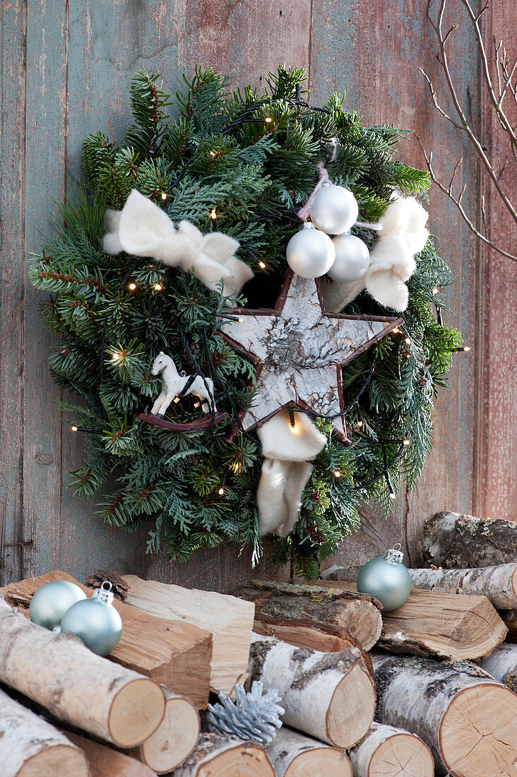 Wreath of fir and cypress with fairy lights, star and baubles