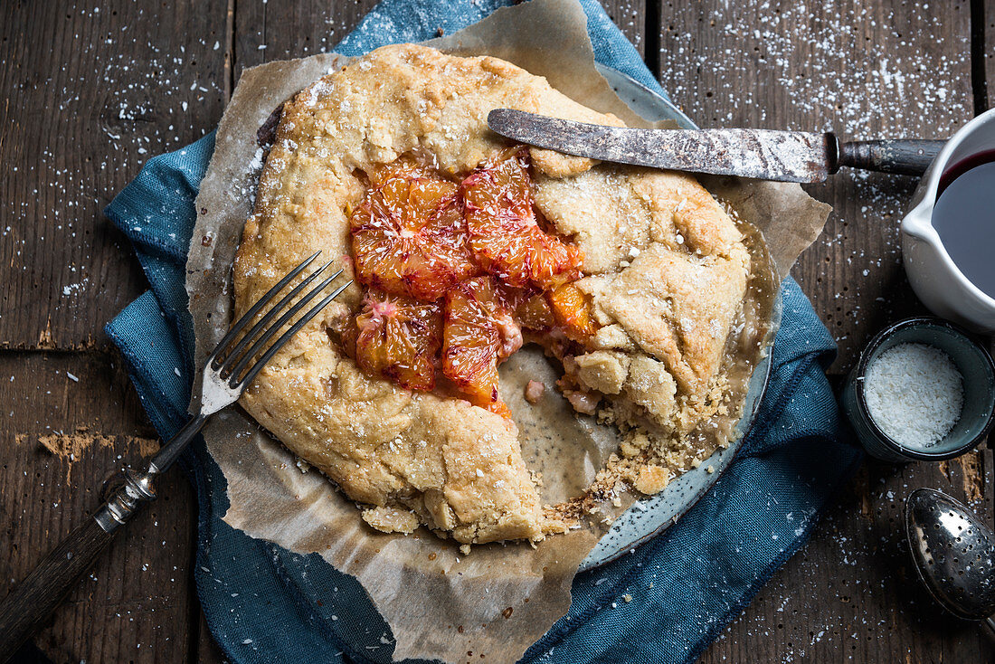 Vegan galette, filled with coconut pudding and blood oranges, sliced