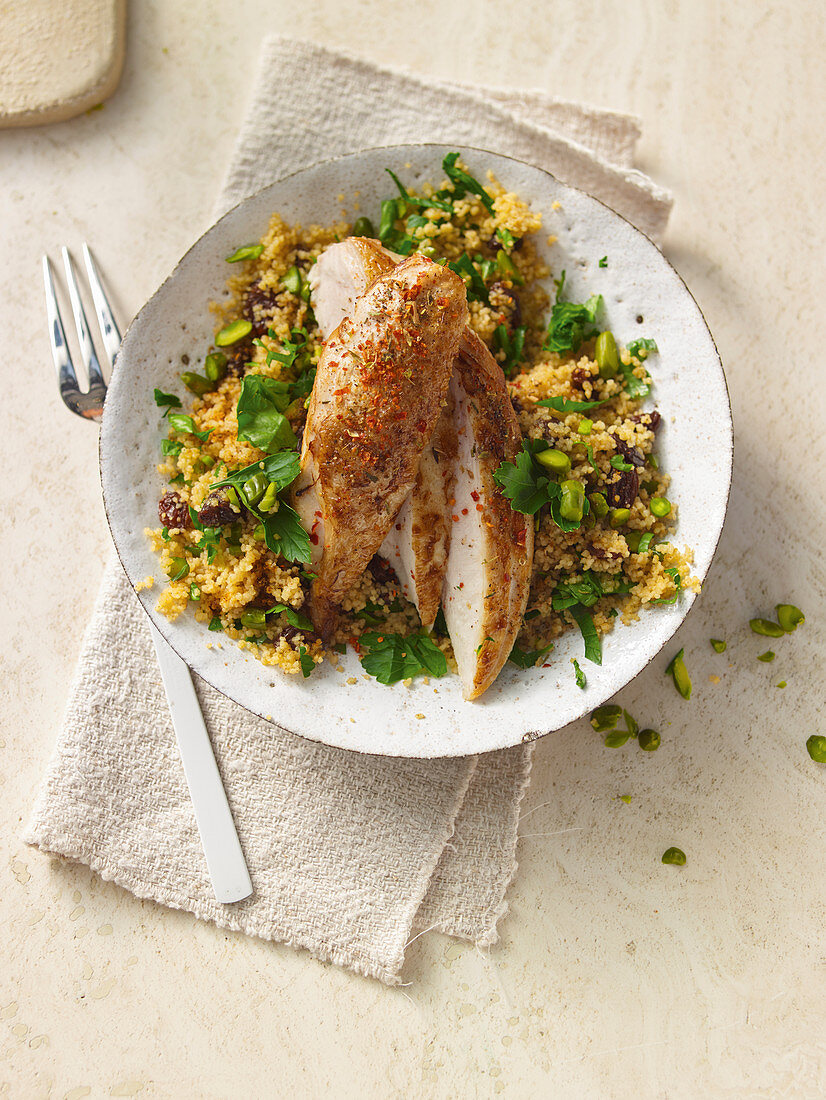 Chicken on orange spice couscous with pistachios and sultanas