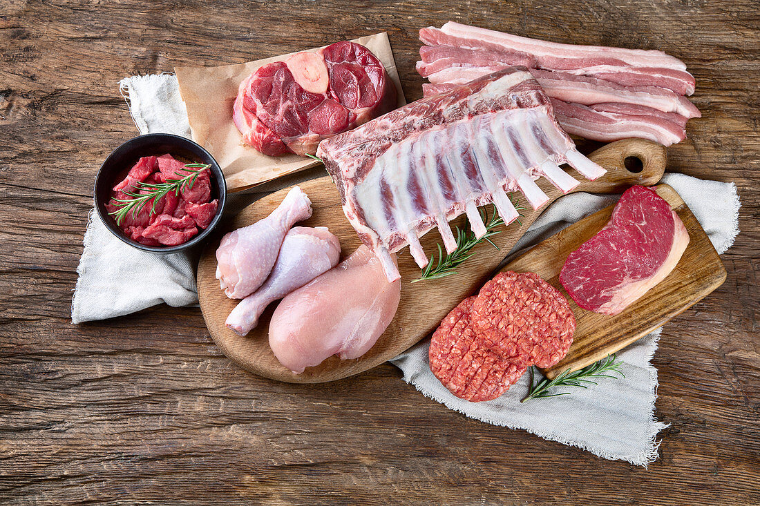 Various types of meat on wooden table