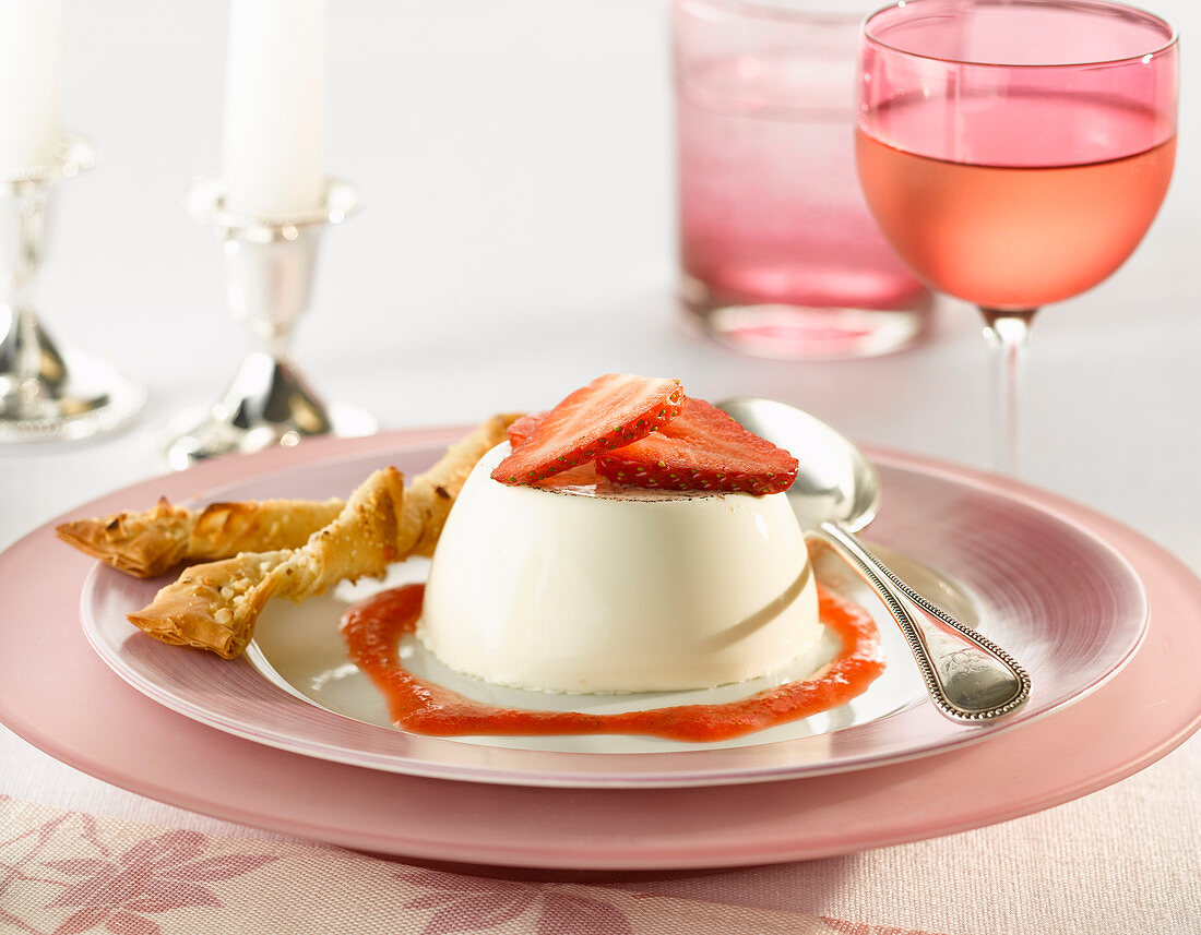 Strawberry panna cotta with a filo pastry twist and coulis with a glass of rose wine