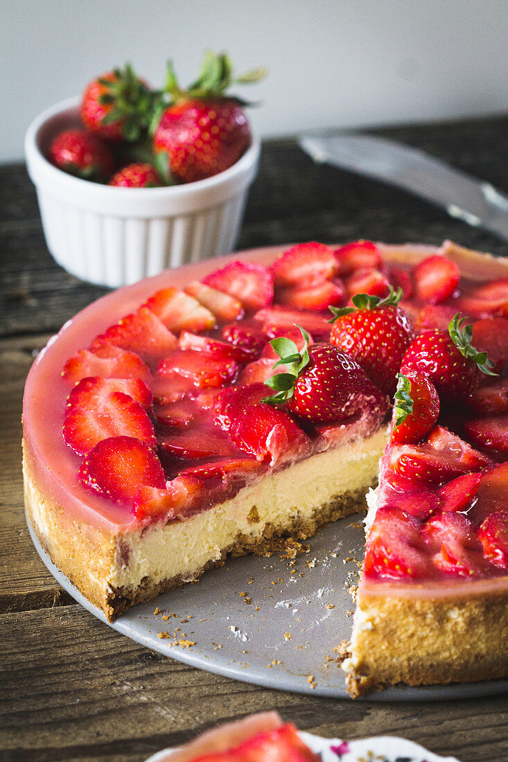 Strawberry cheesecake with an almond base, sliced