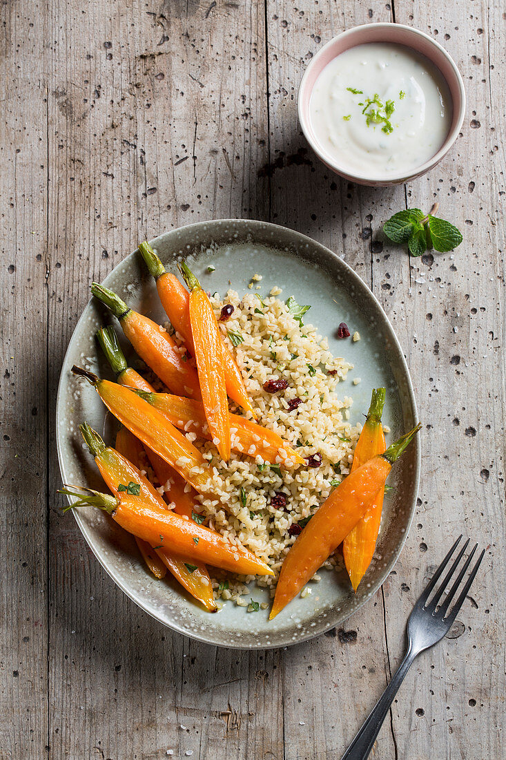 Bulgur with cranberries served with carrots and mint yoghurt