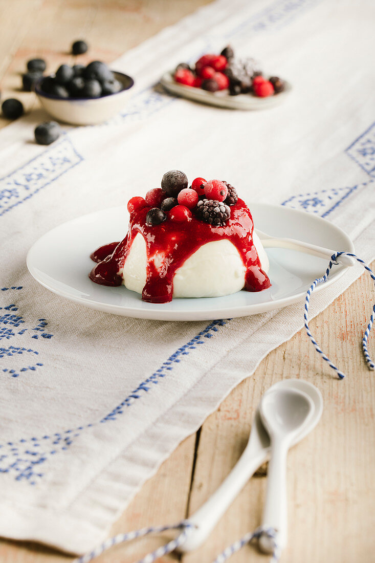 Panna cotta with gooseberries, blackberries and blueberries