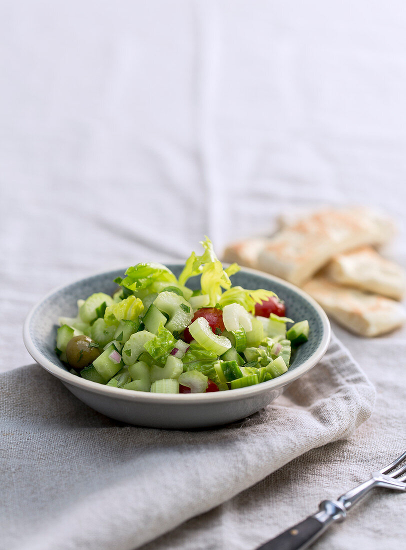 Iceberg lettuce with celery, cucumber, tomatoes and olives