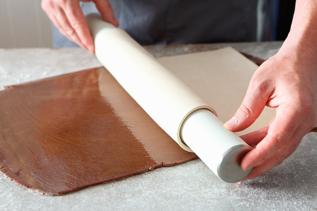 Light pastry being placed on top chocolate dough