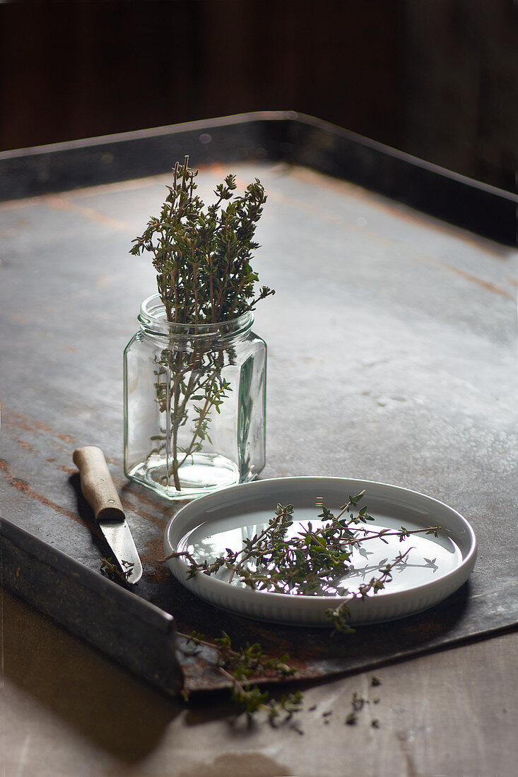 Fresh thyme in a glass and on a dish
