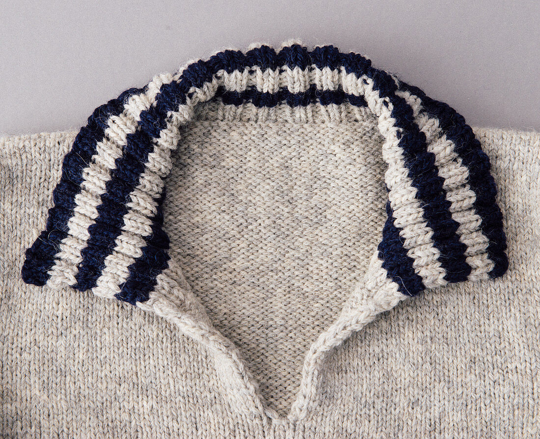 A hand-knitted striped jumper with a collar