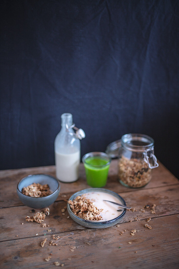 A healthy breakfast with muesli and a smoothie on a rustic wooden table