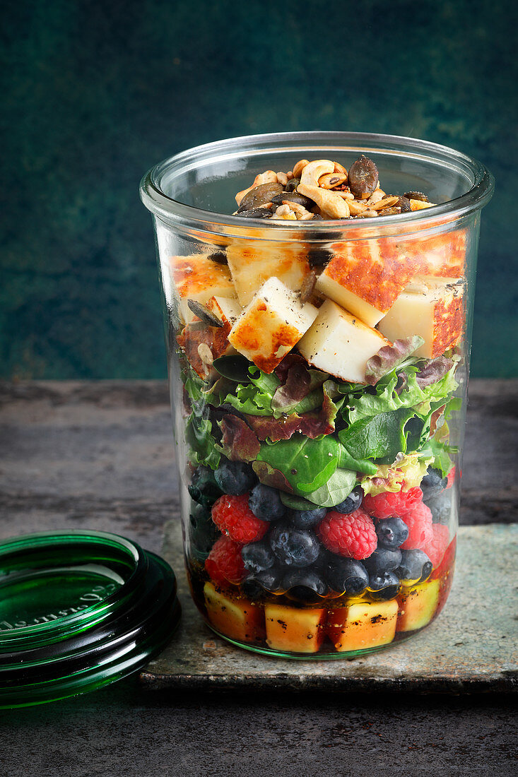 A layered salad with berries and halloumi