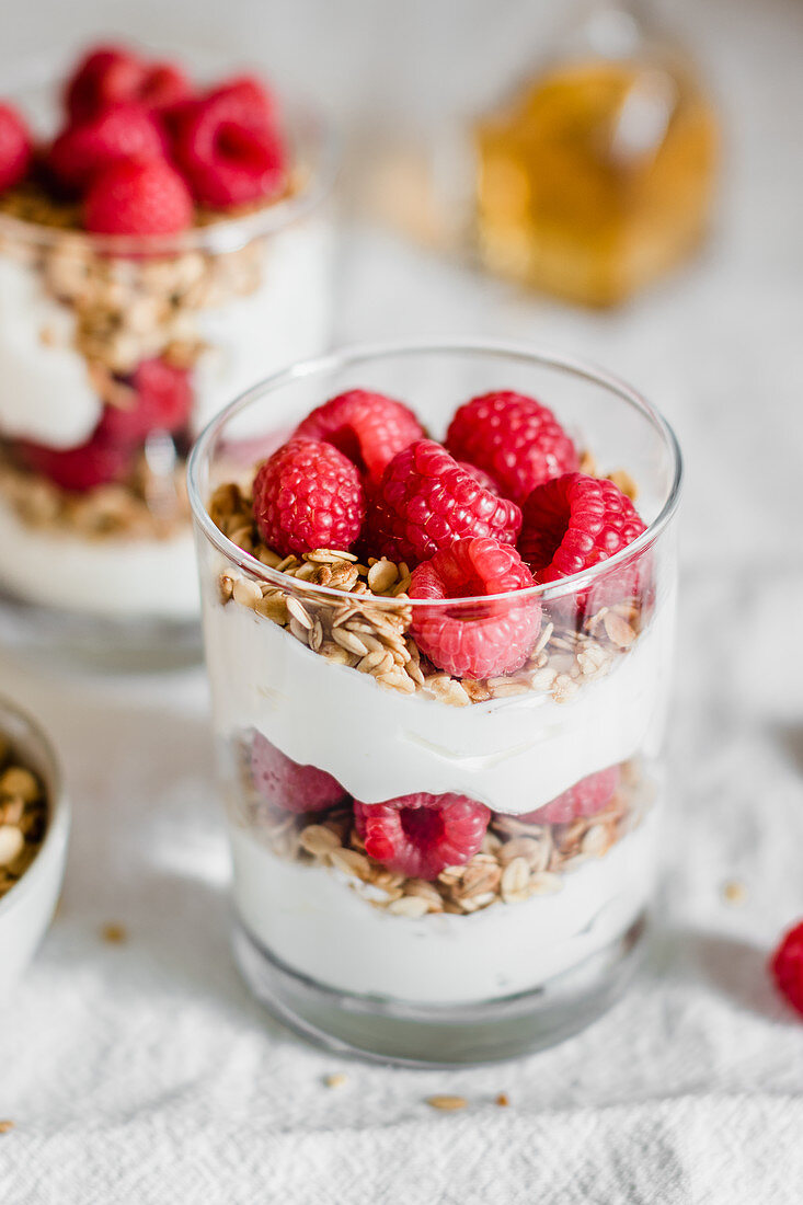 Granola with greek yougurt and raspberries in a glass