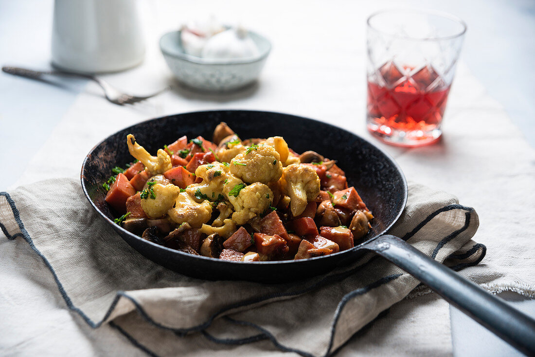 Vegan cauliflower and coconut curry with mushrooms and potatoes marinated in beetroot juice