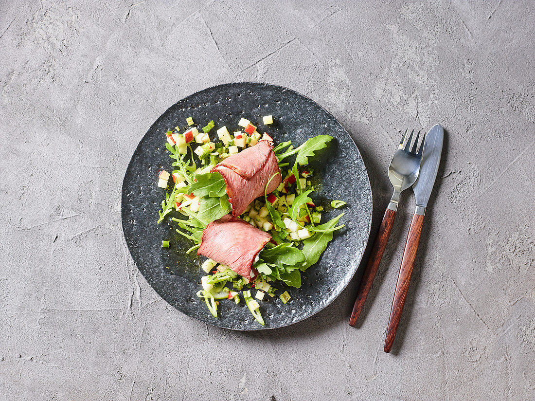 Gorgonzola and roast beef rolls on an apple and celery salad