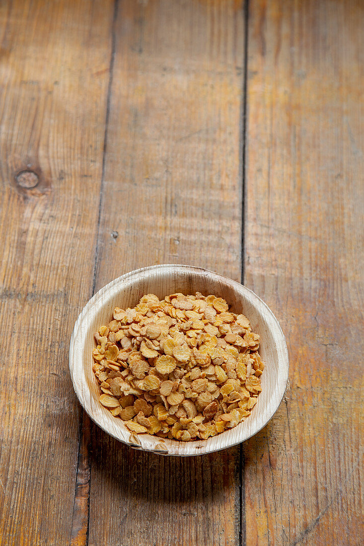 Soya flakes in a wooden bowl