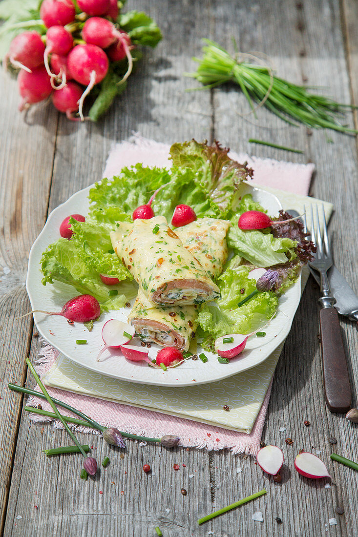 Herb pancakes with salmon and radish filling