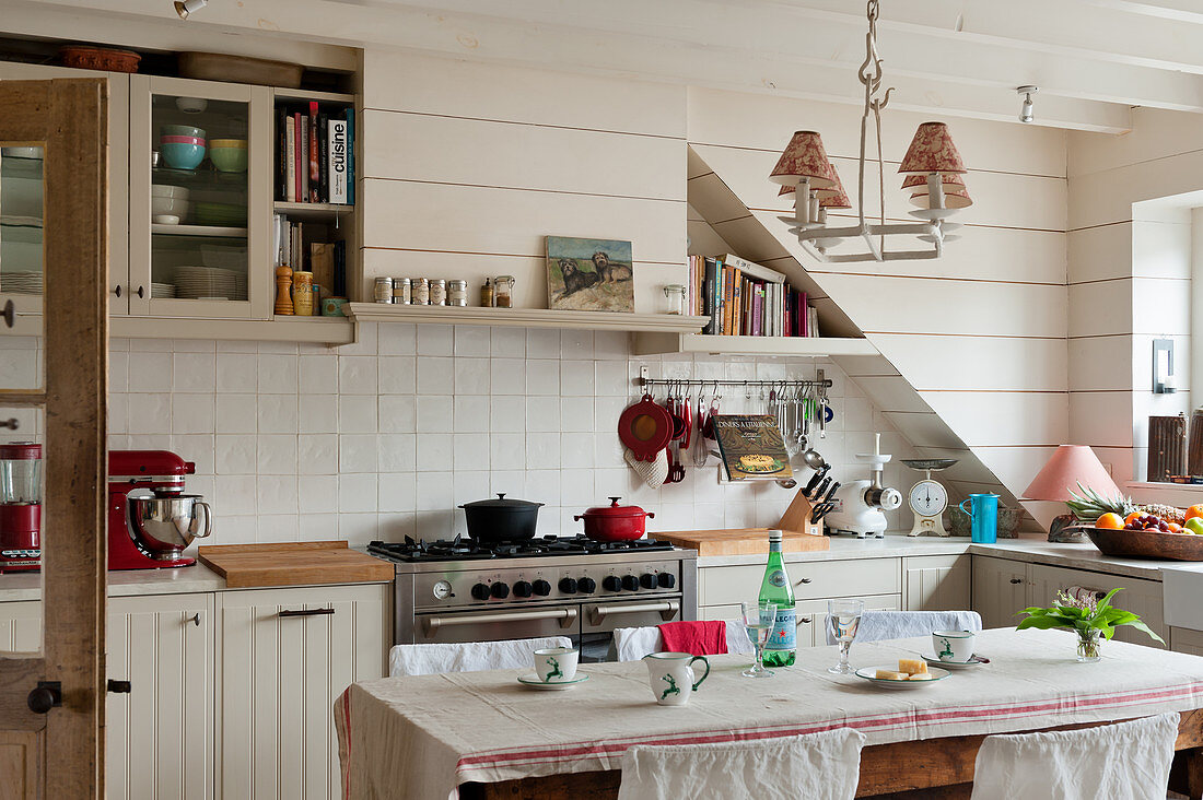 Casserole dishes on range oven in tiled kitchen