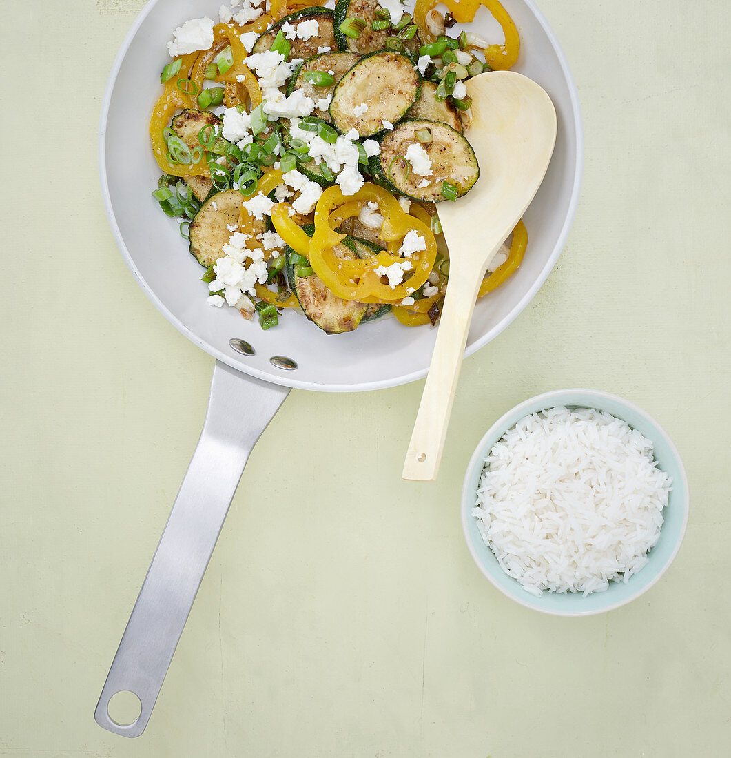 Colourful stir-fried courgettes with peppers and feta cheese