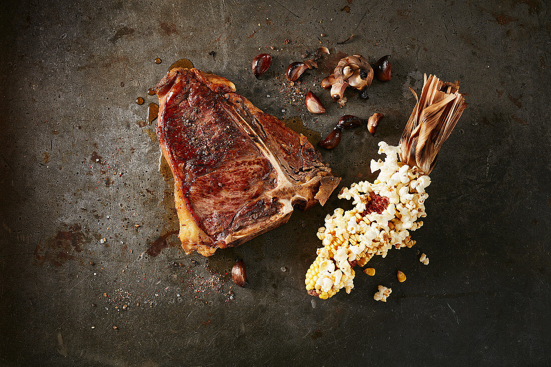 A T-bone steak and popcorn