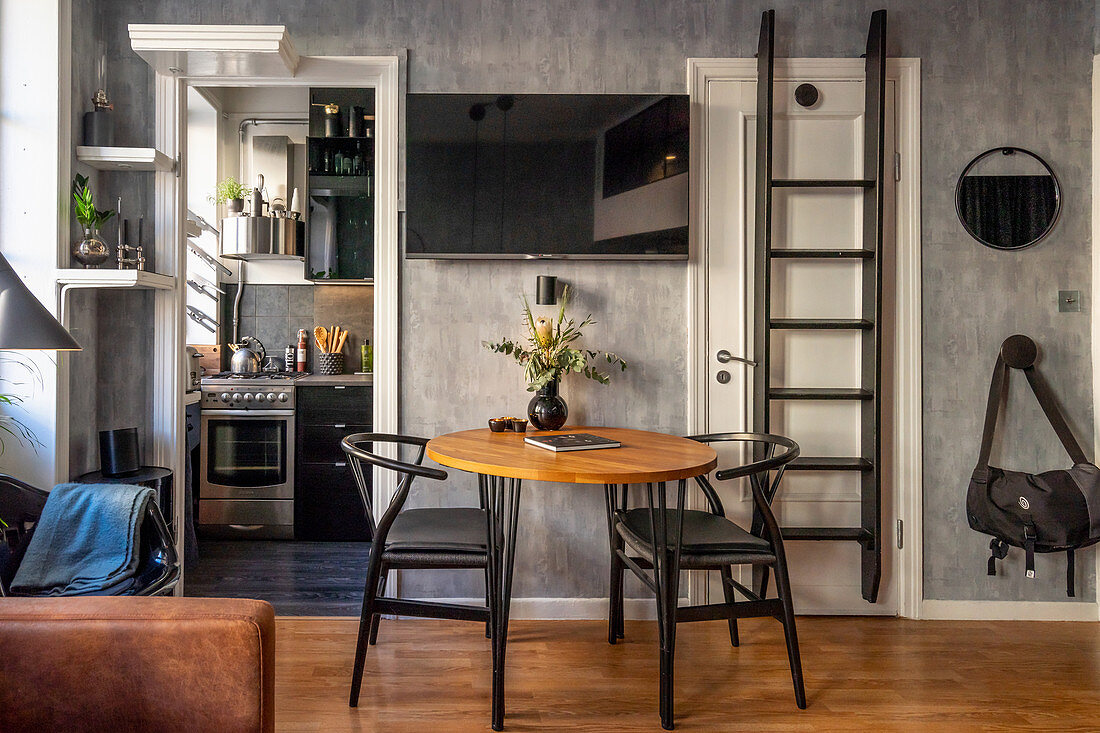 Two chairs at round table in grey, masculine living room