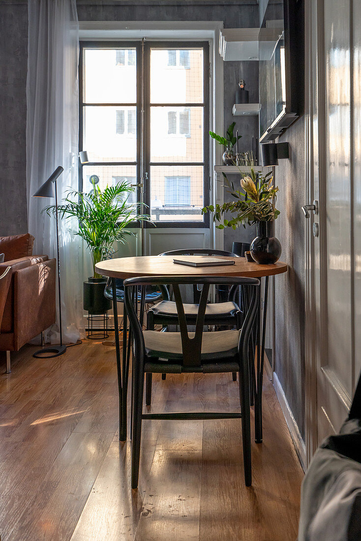 Two chairs at round table in grey, masculine living room