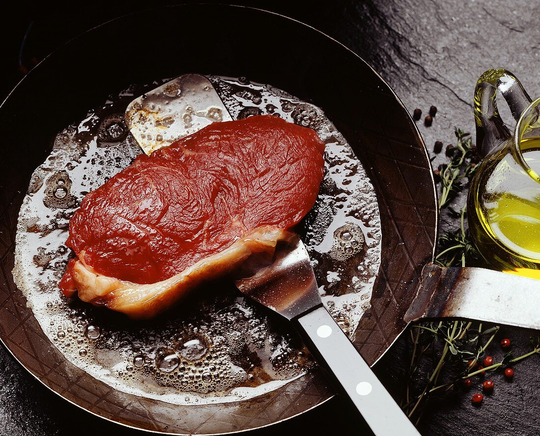 Rump steak frying in the pan
