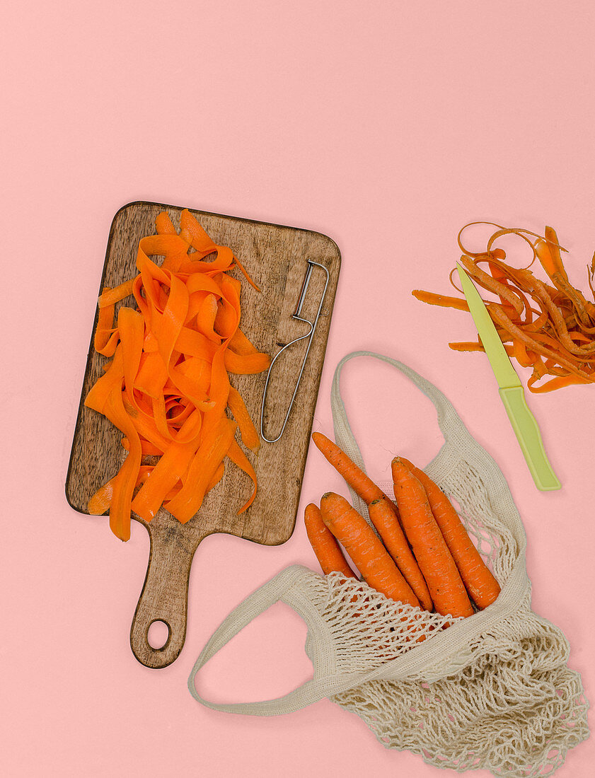Carrots being cut into ribbons with a peeler