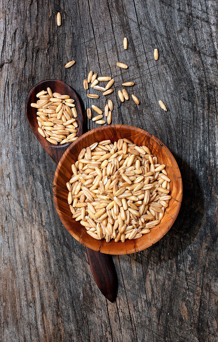 Oat grains in a wooden bowl