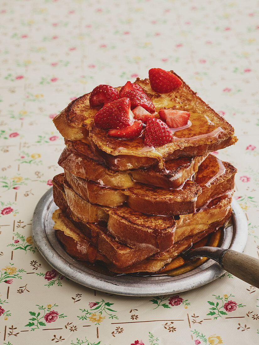 Sweet French toast with strawberries and maple syrup