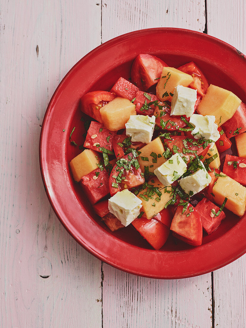Tomato salad with melon, feta cheese and mint