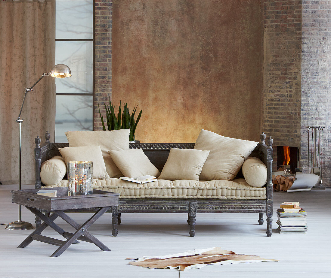 Oriental couch with beige cushions and tray table