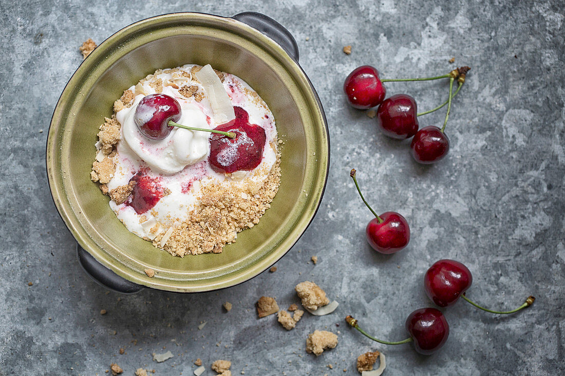 Ice cream with cherries on a metal background