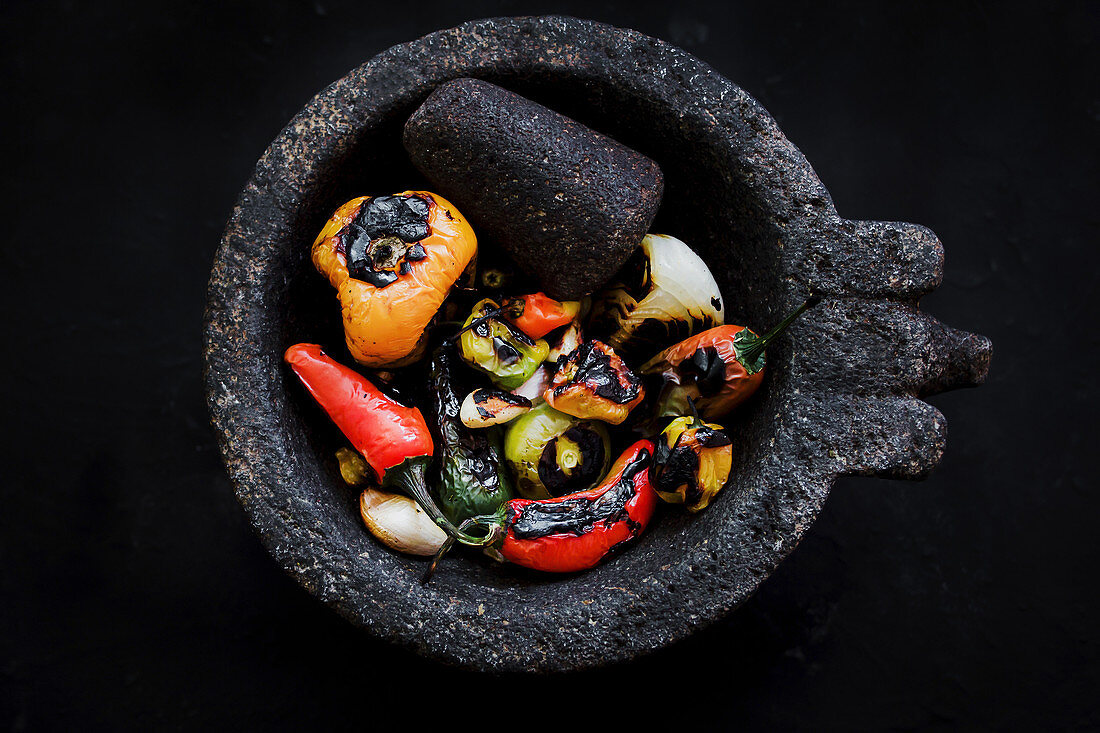 Roasted vegetables placed on black tray in kitchen