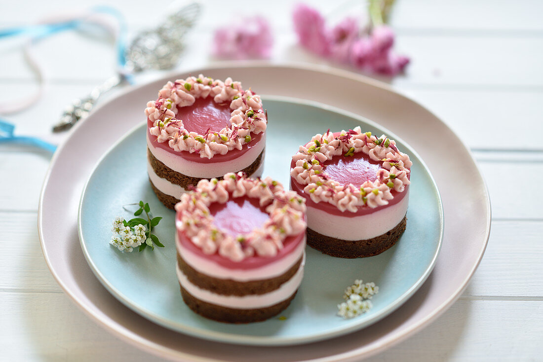 Vegan pink dragon fruit cream cheese tarts with chocolate biscuit bases and fruit mirror glazes