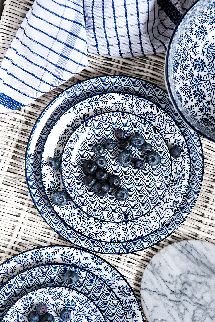 Blueberries on blue and white dishes