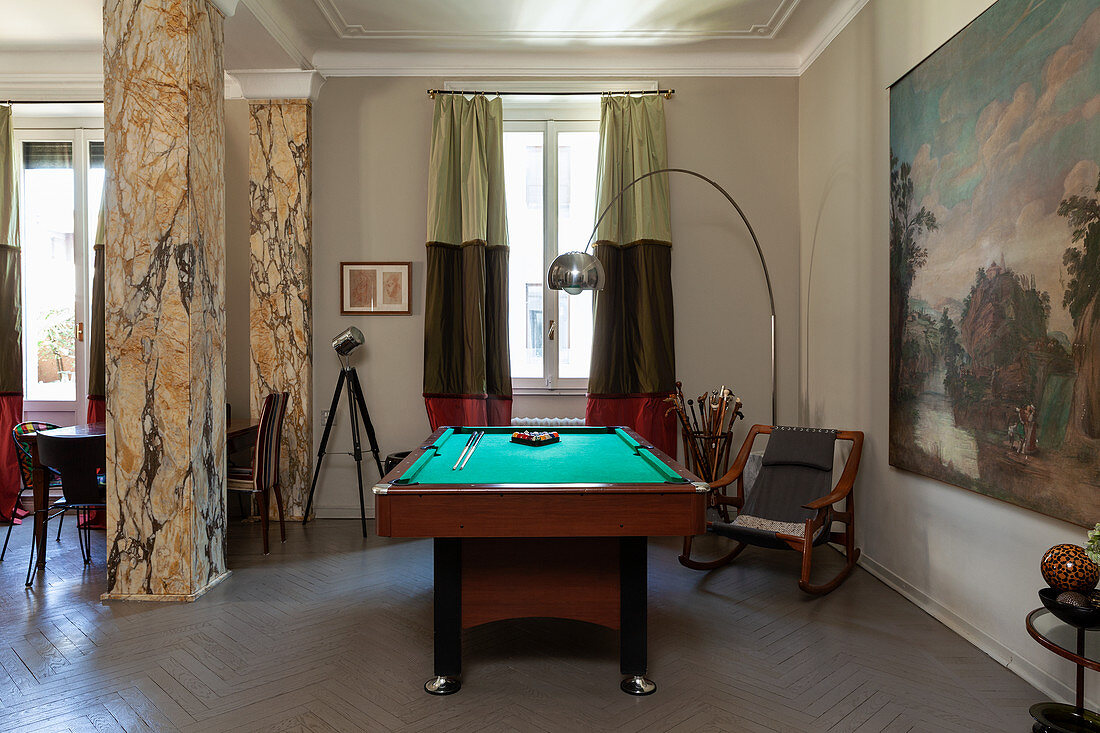 Pool table in open-plan interior with marble pillars