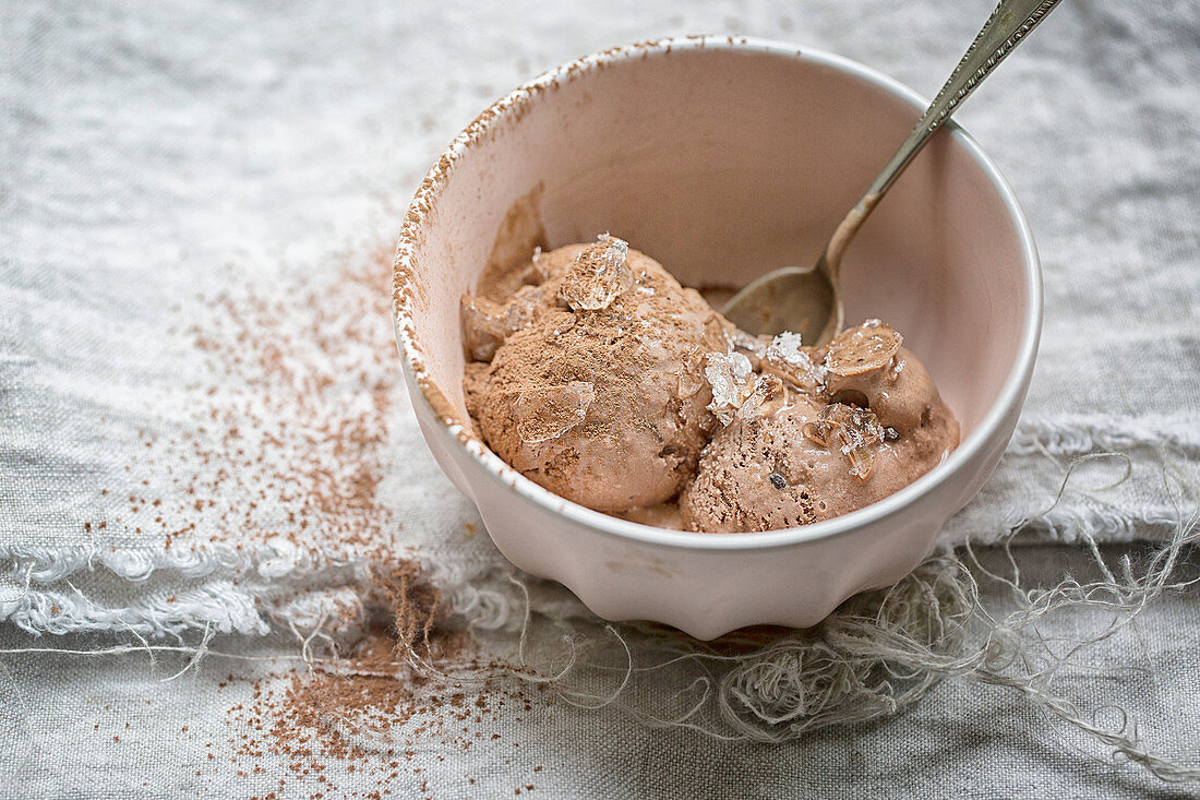 Pink bowl of Chocolate Ice Cream on a linen cloth